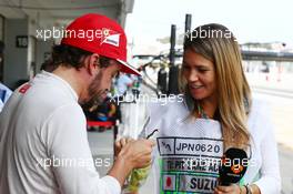 (L to R): Fernando Alonso (ESP) Ferrari with Nira Juanco (ESP) Antena 3 TV Presenter. 03.10.2014. Formula 1 World Championship, Rd 15, Japanese Grand Prix, Suzuka, Japan, Practice Day.