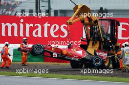 Marshals recover the Ferrari F14-T of race retiree Fernando Alonso (ESP) Ferrari with a digger. 05.10.2014. Formula 1 World Championship, Rd 15, Japanese Grand Prix, Suzuka, Japan, Race Day.