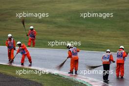 Marshals clear the track of surface water. 05.10.2014. Formula 1 World Championship, Rd 15, Japanese Grand Prix, Suzuka, Japan, Race Day.