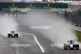 Lewis Hamilton (GBR) Mercedes AMG F1 W05 exits the pits behind team mate Nico Rosberg (GER) Mercedes AMG F1 W05. 05.10.2014. Formula 1 World Championship, Rd 15, Japanese Grand Prix, Suzuka, Japan, Race Day.