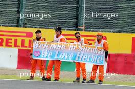 Marshals and fans of Herbie Blash (GBR) FIA Delegate. 04.10.2014. Formula 1 World Championship, Rd 15, Japanese Grand Prix, Suzuka, Japan, Qualifying Day.