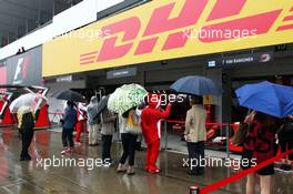 Fans in wet and rainy pit lane. 05.10.2014. Formula 1 World Championship, Rd 15, Japanese Grand Prix, Suzuka, Japan, Race Day.