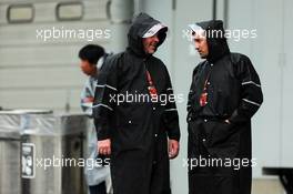 (L to R): Jason Swales (GBR) NBC Sports Network and Will Buxton (GBR) NBS Sports Network TV Presenter in a wet and rainy paddock. 05.10.2014. Formula 1 World Championship, Rd 15, Japanese Grand Prix, Suzuka, Japan, Race Day.