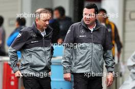 (L to R): Jonathan Neale (GBR) McLaren Chief Operating Officer and Eric Boullier (FRA) McLaren Racing Director in a wet and rainy paddock. 05.10.2014. Formula 1 World Championship, Rd 15, Japanese Grand Prix, Suzuka, Japan, Race Day.