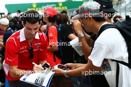 Alexander Rossi (USA) Marussia F1 Team Reserve Driver signs autographs for the fans. 02.10.2014. Formula 1 World Championship, Rd 15, Japanese Grand Prix, Suzuka, Japan, Preparation Day.