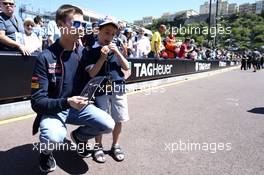 Daniil Kvyat (RUS) Scuderia Toro Rosso with a young fan. 23.05.2014. Formula 1 World Championship, Rd 6, Monaco Grand Prix, Monte Carlo, Monaco, Friday.