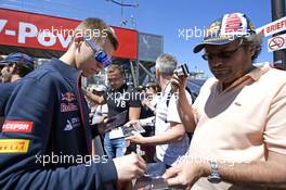 Daniil Kvyat (RUS) Scuderia Toro Rosso signs autographs for the fans. 23.05.2014. Formula 1 World Championship, Rd 6, Monaco Grand Prix, Monte Carlo, Monaco, Friday.