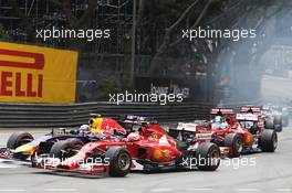 Kimi Raikkonen (FIN) Ferrari F14-T and Daniel Ricciardo (AUS) Red Bull Racing RB10 battle for position at the start of the race. 25.05.2014. Formula 1 World Championship, Rd 6, Monaco Grand Prix, Monte Carlo, Monaco, Race Day.