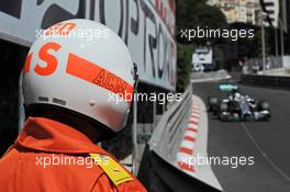 A marshal watches Lewis Hamilton (GBR) Mercedes AMG F1 W05. 24.05.2014. Formula 1 World Championship, Rd 6, Monaco Grand Prix, Monte Carlo, Monaco, Qualifying Day