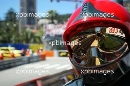 Sebastian Vettel (GER) Red Bull Racing RB10 reflected in a fireman's helmet visor. 24.05.2014. Formula 1 World Championship, Rd 6, Monaco Grand Prix, Monte Carlo, Monaco, Qualifying Day