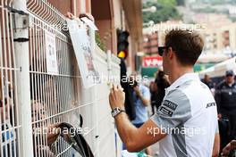 Jenson Button (GBR) McLaren signs autographs for the fans. 22.05.2014. Formula 1 World Championship, Rd 6, Monaco Grand Prix, Monte Carlo, Monaco, Practice Day.