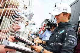 Nico Rosberg (GER) Mercedes AMG F1 signs autographs for the fans. 21.05.2014. Formula 1 World Championship, Rd 6, Monaco Grand Prix, Monte Carlo, Monaco, Preparation Day.