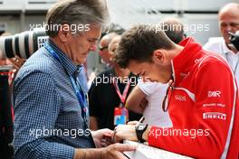 Jules Bianchi (FRA) Marussia F1 Team writes a message of support for Michael Schumacher. 21.05.2014. Formula 1 World Championship, Rd 6, Monaco Grand Prix, Monte Carlo, Monaco, Preparation Day.