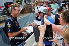 Sebastian Vettel (GER) Red Bull Racing signs autographs for the fans. 21.05.2014. Formula 1 World Championship, Rd 6, Monaco Grand Prix, Monte Carlo, Monaco, Preparation Day.