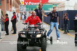 Sebastian Vettel (GER) Red Bull Racing hitches a lift from a Marussia F1 Team mechanic. 21.05.2014. Formula 1 World Championship, Rd 6, Monaco Grand Prix, Monte Carlo, Monaco, Preparation Day.