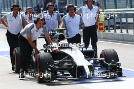 Kevin Magnussen (DEN) McLaren MP4-29 is pushed down the pit lane after stopping on track. 28.03.2014. Formula 1 World Championship, Rd 2, Malaysian Grand Prix, Sepang, Malaysia, Friday.