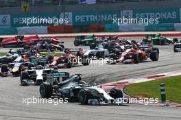 Lewis Hamilton (GBR) Mercedes AMG F1 W05 leads at the start of the race. 30.03.2014. Formula 1 World Championship, Rd 2, Malaysian Grand Prix, Sepang, Malaysia, Sunday.