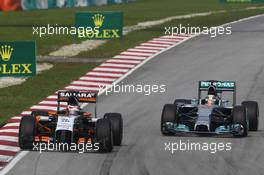 Nico Hulkenberg (GER) Sahara Force India F1 VJM07 leads Lewis Hamilton (GBR) Mercedes AMG F1 W05. 30.03.2014. Formula 1 World Championship, Rd 2, Malaysian Grand Prix, Sepang, Malaysia, Sunday.