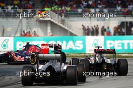 Daniil Kvyat (RUS) Scuderia Toro Rosso STR9 leads Romain Grosjean (FRA) Lotus F1 E22 and Adrian Sutil (GER) Sauber C33. 30.03.2014. Formula 1 World Championship, Rd 2, Malaysian Grand Prix, Sepang, Malaysia, Sunday.