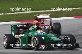 Marcus Ericsson (SWE) Caterham CT05 leads Kimi Raikkonen (FIN) Ferrari F14-T. 30.03.2014. Formula 1 World Championship, Rd 2, Malaysian Grand Prix, Sepang, Malaysia, Sunday.