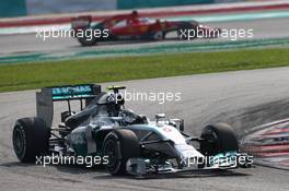 Nico Rosberg (GER) Mercedes AMG F1 W05 leads Fernando Alonso (ESP) Ferrari. 30.03.2014. Formula 1 World Championship, Rd 2, Malaysian Grand Prix, Sepang, Malaysia, Sunday.