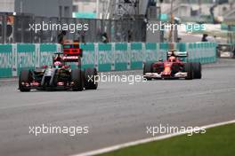 Romain Grosjean (FRA), Lotus F1 Team and Kimi Raikkonen (FIN), Scuderia Ferrari  30.03.2014. Formula 1 World Championship, Rd 2, Malaysian Grand Prix, Sepang, Malaysia, Sunday.