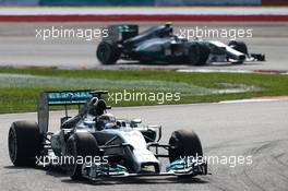 Lewis Hamilton (GBR) Mercedes AMG F1 W05 leads team mate Nico Rosberg (GER) Mercedes AMG F1 W05. 30.03.2014. Formula 1 World Championship, Rd 2, Malaysian Grand Prix, Sepang, Malaysia, Sunday.