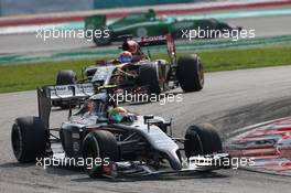 Esteban Gutierrez (MEX) Sauber leads Romain Grosjean (FRA) Lotus F1 E22. 30.03.2014. Formula 1 World Championship, Rd 2, Malaysian Grand Prix, Sepang, Malaysia, Sunday.