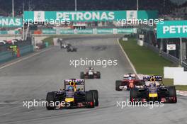 (L to R): Sebastian Vettel (GER) Red Bull Racing RB10 and team mate Daniel Ricciardo (AUS) Red Bull Racing RB10 battle for position. 30.03.2014. Formula 1 World Championship, Rd 2, Malaysian Grand Prix, Sepang, Malaysia, Sunday.