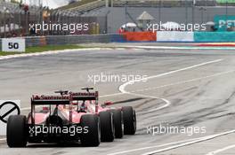 Kimi Raikkonen (FIN) Ferrari F14-T and Fernando Alonso (ESP) Ferrari F14-T at the end of the pit lane. 29.03.2014. Formula 1 World Championship, Rd 2, Malaysian Grand Prix, Sepang, Malaysia, Saturday.