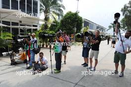 Photographers in the paddock. 29.03.2014. Formula 1 World Championship, Rd 2, Malaysian Grand Prix, Sepang, Malaysia, Saturday.