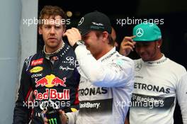 Sebastian Vettel (GER) Red Bull Racing and Nico Rosberg (GER) Mercedes AMG F1 W05. 29.03.2014. Formula 1 World Championship, Rd 2, Malaysian Grand Prix, Sepang, Malaysia, Saturday.