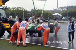 The Caterham CT05 of Marcus Ericsson (SWE) Caterham is recovered by marshalls after he crashed in qualifying. 29.03.2014. Formula 1 World Championship, Rd 2, Malaysian Grand Prix, Sepang, Malaysia, Saturday.