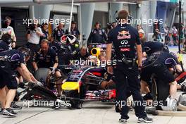 Sebastian Vettel (GER) Red Bull Racing RB10 practices a pit stop. 29.03.2014. Formula 1 World Championship, Rd 2, Malaysian Grand Prix, Sepang, Malaysia, Saturday.