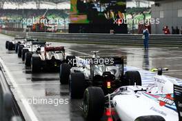 Jenson Button (GBR) McLaren MP4-29 and Valtteri Bottas (FIN) Williams FW36 at the back of the queue as qualifying begins. 29.03.2014. Formula 1 World Championship, Rd 2, Malaysian Grand Prix, Sepang, Malaysia, Saturday.