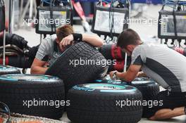 Mercedes AMG F1 mechanics prepare wet Pirelli tyres. 27.03.2014. Formula 1 World Championship, Rd 2, Malaysian Grand Prix, Sepang, Malaysia, Thursday.