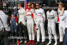 (L to R): Nico Hulkenberg (GER) Sahara Force India F1; Max Chilton (GBR) Marussia F1 Team; Jenson Button (GBR) McLaren; Lewis Hamilton (GBR) Mercedes AMG F1; Kevin Magnussen (DEN) McLaren and the other drivers observe a tribute to Jules Bianchi and the Russian national anthem. 12.10.2014. Formula 1 World Championship, Rd 16, Russian Grand Prix, Sochi Autodrom, Sochi, Russia, Race Day.