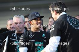 Lewis Hamilton (GBR) Mercedes AMG F1 celebrates winning the 2014 Constructors' Championship with Toto Wolff (GER) Mercedes AMG F1 Shareholder and Executive Director and the team. 12.10.2014. Formula 1 World Championship, Rd 16, Russian Grand Prix, Sochi Autodrom, Sochi, Russia, Race Day.