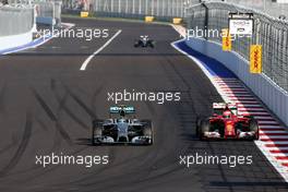 Nico Rosberg (GER), Mercedes AMG F1 Team and Kimi Raikkonen (FIN), Scuderia Ferrari  12.10.2014. Formula 1 World Championship, Rd 16, Russian Grand Prix, Sochi Autodrom, Sochi, Russia, Race Day.