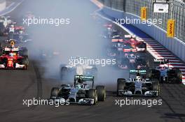 (L to R): Nico Rosberg (GER) Mercedes AMG F1 locks up under braking beside team mate Lewis Hamilton (GBR) Mercedes AMG F1 W05 at the start of the race. 12.10.2014. Formula 1 World Championship, Rd 16, Russian Grand Prix, Sochi Autodrom, Sochi, Russia, Race Day.