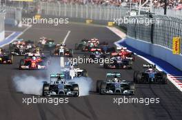 (L to R): Nico Rosberg (GER) Mercedes AMG F1 locks up under braking beside team mate Lewis Hamilton (GBR) Mercedes AMG F1 W05 at the start of the race. 12.10.2014. Formula 1 World Championship, Rd 16, Russian Grand Prix, Sochi Autodrom, Sochi, Russia, Race Day.