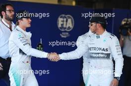 (L to R): second placed Nico Rosberg (GER) Mercedes AMG F1 congratulates team mate and pole sitter Lewis Hamilton (GBR) Mercedes AMG F1 in parc ferme. 11.10.2014. Formula 1 World Championship, Rd 16, Russian Grand Prix, Sochi Autodrom, Sochi, Russia, Qualifying Day.