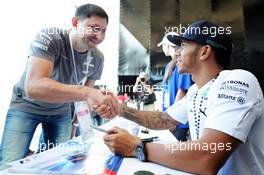 Lewis Hamilton (GBR) Mercedes AMG F1 signs autographs for the fans at the Fanzone. 09.10.2014. Formula 1 World Championship, Rd 16, Russian Grand Prix, Sochi Autodrom, Sochi, Russia, Preparation Day.