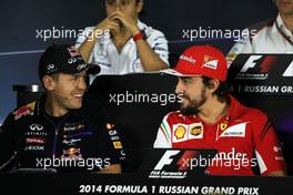 (L to R): Sebastian Vettel (GER) Red Bull Racing and Fernando Alonso (ESP) Ferrari in the FIA Press Conference. 09.10.2014. Formula 1 World Championship, Rd 16, Russian Grand Prix, Sochi Autodrom, Sochi, Russia, Preparation Day.