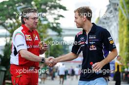 (L to R): Pat Fry (GBR) Ferrari Deputy Technical Director and Head of Race Engineering with Sebastian Vettel (GER) Red Bull Racing. 19.09.2014. Formula 1 World Championship, Rd 14, Singapore Grand Prix, Singapore, Singapore, Practice Day.