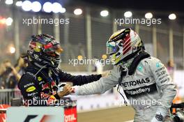 (L to R): Second placed Sebastian Vettel (GER) Red Bull Racing celebrates with race winner Lewis Hamilton (GBR) Mercedes AMG F1 in parc ferme. 21.09.2014. Formula 1 World Championship, Rd 14, Singapore Grand Prix, Singapore, Singapore, Race Day.
