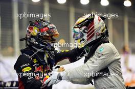 (L to R): Second placed Sebastian Vettel (GER) Red Bull Racing celebrates with race winner Lewis Hamilton (GBR) Mercedes AMG F1 in parc ferme. 21.09.2014. Formula 1 World Championship, Rd 14, Singapore Grand Prix, Singapore, Singapore, Race Day.