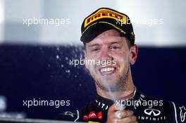 Sebastian Vettel (GER) Red Bull Racing celebrates his second position on the podium. 21.09.2014. Formula 1 World Championship, Rd 14, Singapore Grand Prix, Singapore, Singapore, Race Day.