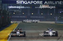 Sergio Perez (MEX) Sahara Force India F1 VJM07 and Valtteri Bottas (FIN) Williams FW36 battle for position. 21.09.2014. Formula 1 World Championship, Rd 14, Singapore Grand Prix, Singapore, Singapore, Race Day.