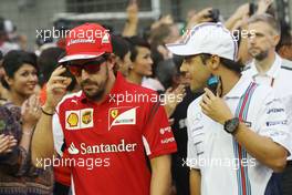 (L to R): Fernando Alonso (ESP) Ferrari with Felipe Massa (BRA) Williams on the drivers parade. 21.09.2014. Formula 1 World Championship, Rd 14, Singapore Grand Prix, Singapore, Singapore, Race Day.